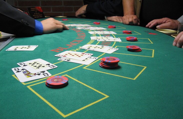 Players sitting a Blackjack table